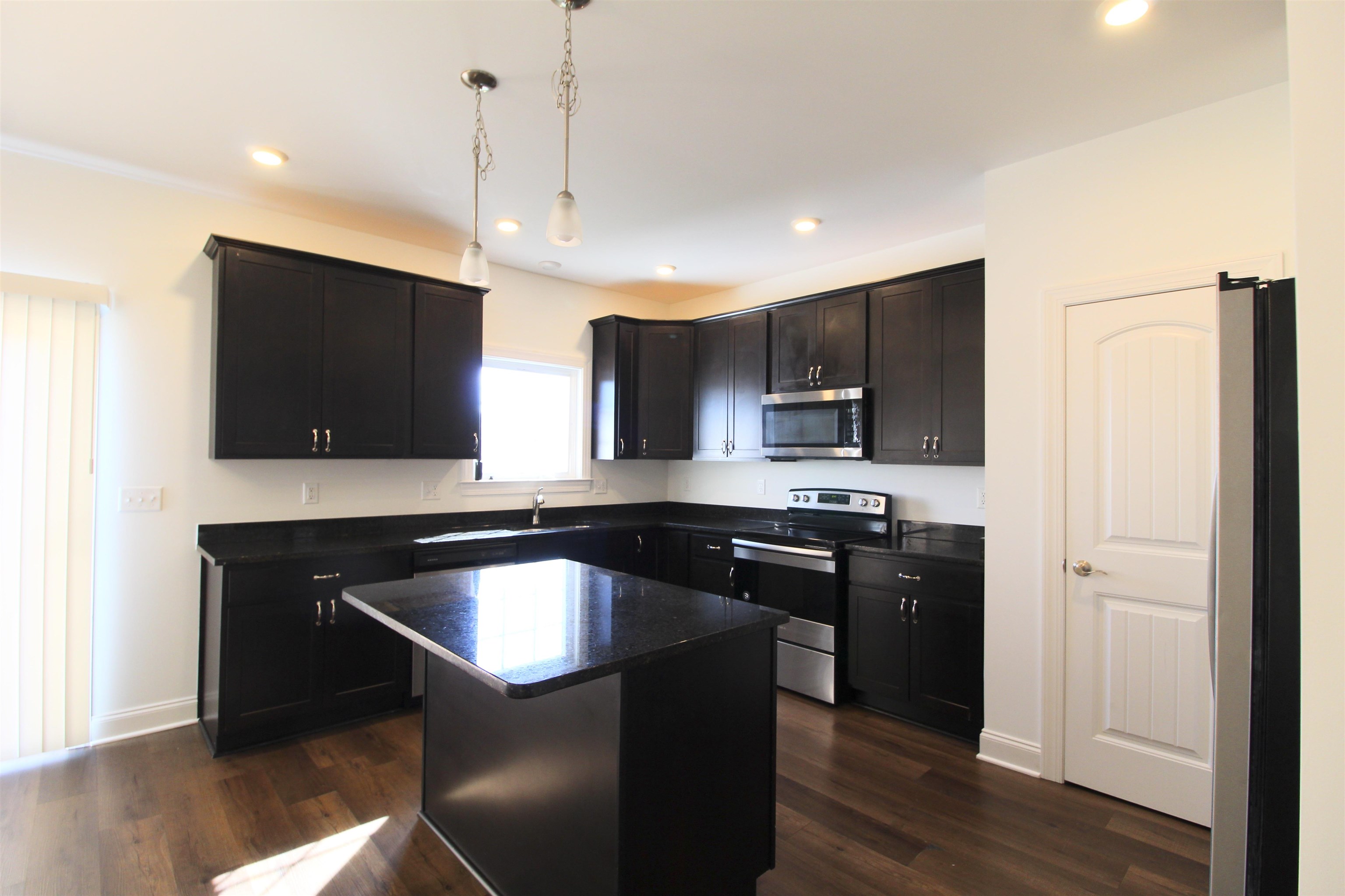 1145 Bluemoon Drive Harrisonburg, VA 22801 - Photo 2 of 18 a kitchen with a sink a microwave a stove and refrigerator