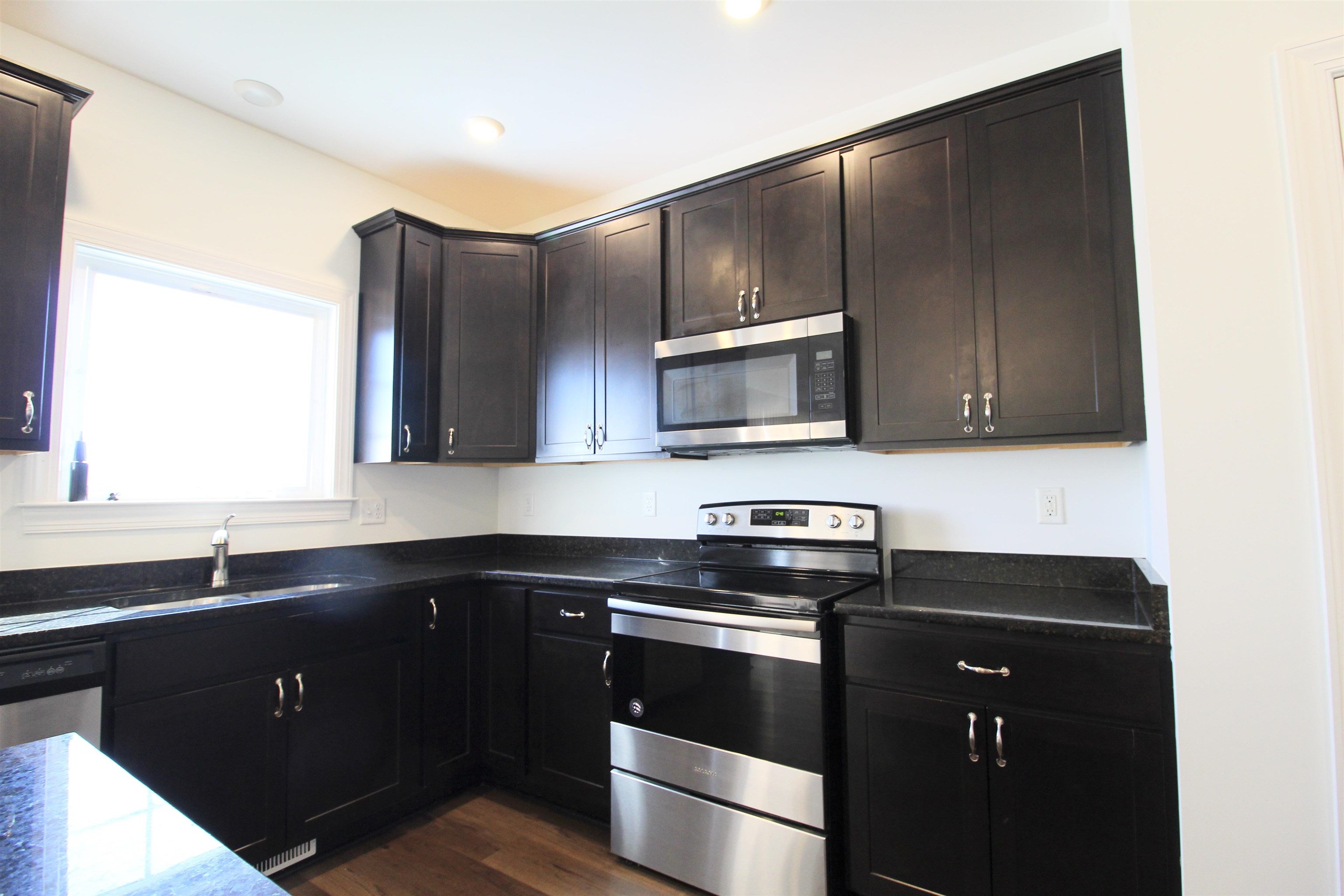1145 Bluemoon Drive Harrisonburg, VA 22801 - Photo 3 of 18 a kitchen with a sink stove and microwave