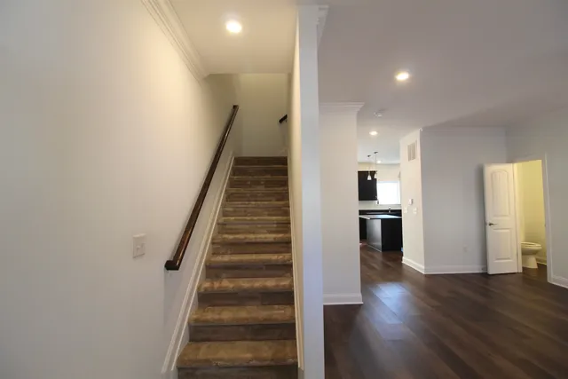 a view of a hallway with wooden floor and entryway