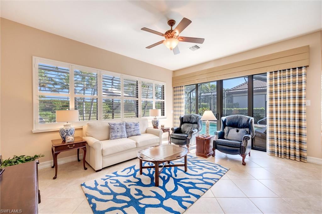 7660 Cottesmore Drive Naples, FL 34113 - Photo 17 of 50 a living room with furniture and a large window