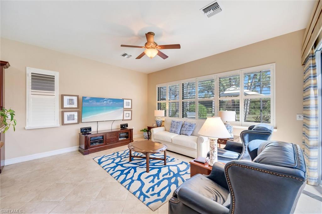 7660 Cottesmore Drive Naples, FL 34113 - Photo 19 of 50 a living room with furniture and a flat screen tv