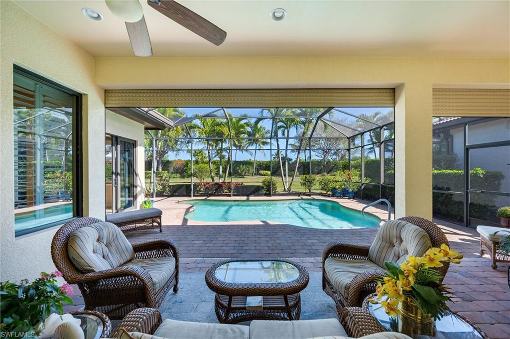 7660 Cottesmore Drive Naples, FL 34113 - Photo 23 of 50 a living room with patio and furniture