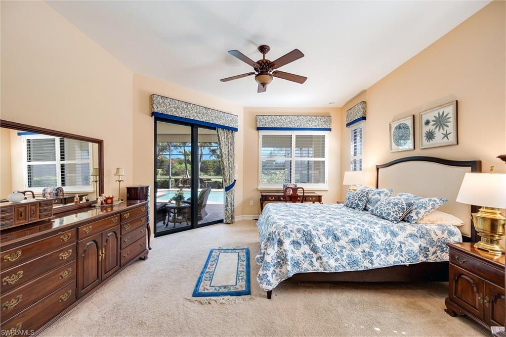 7660 Cottesmore Drive Naples, FL 34113 - Photo 29 of 50 a bedroom with a bed and a large window