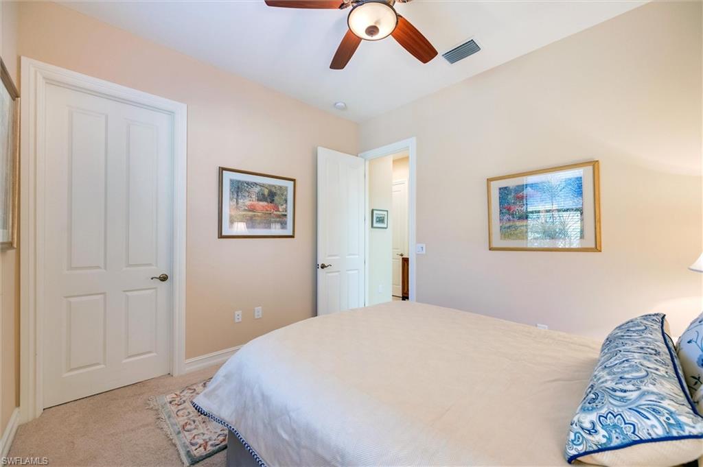 7660 Cottesmore Drive Naples, FL 34113 - Photo 36 of 50 a bedroom with a bed and a painting on the wall
