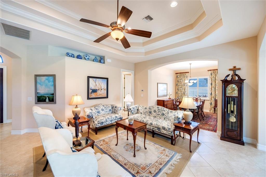 7660 Cottesmore Drive Naples, FL 34113 - Photo 5 of 50 a living room with furniture and wooden floor