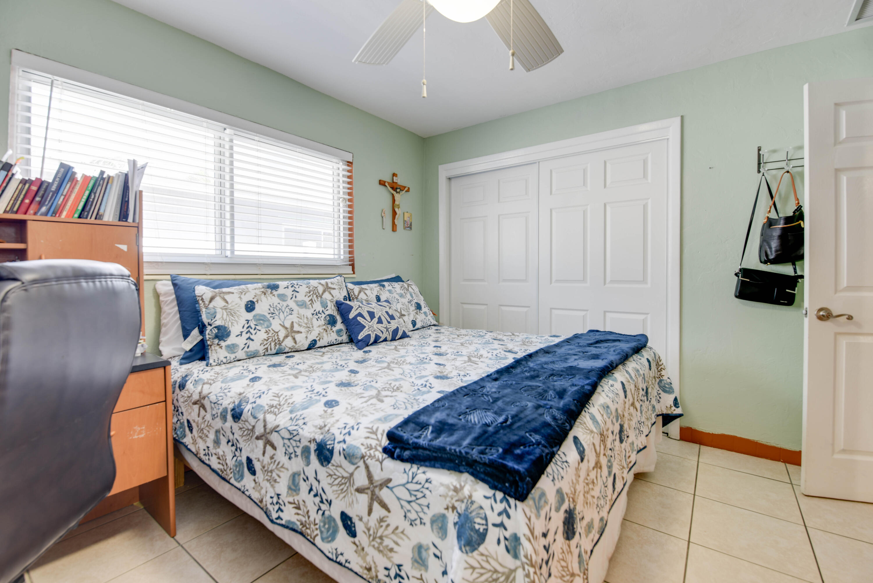 1524 5th Street Key West, FL 33040 - Photo 13 of 31 a bedroom with a bed and a chandelier