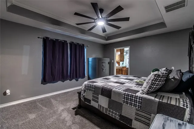 a bedroom with bed and wooden floor