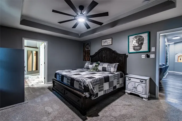 a spacious bedroom with a bed and a chandelier