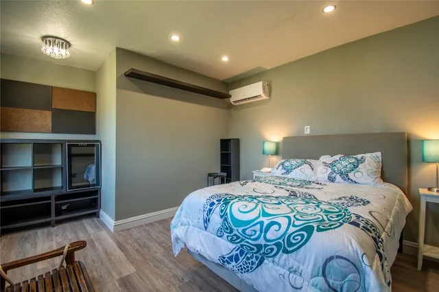 a bedroom with a bed and wooden floor