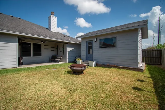 a backyard of a house with table and chairs