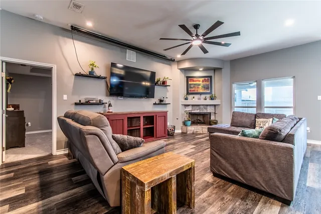 a living room with furniture a fireplace and a flat screen tv
