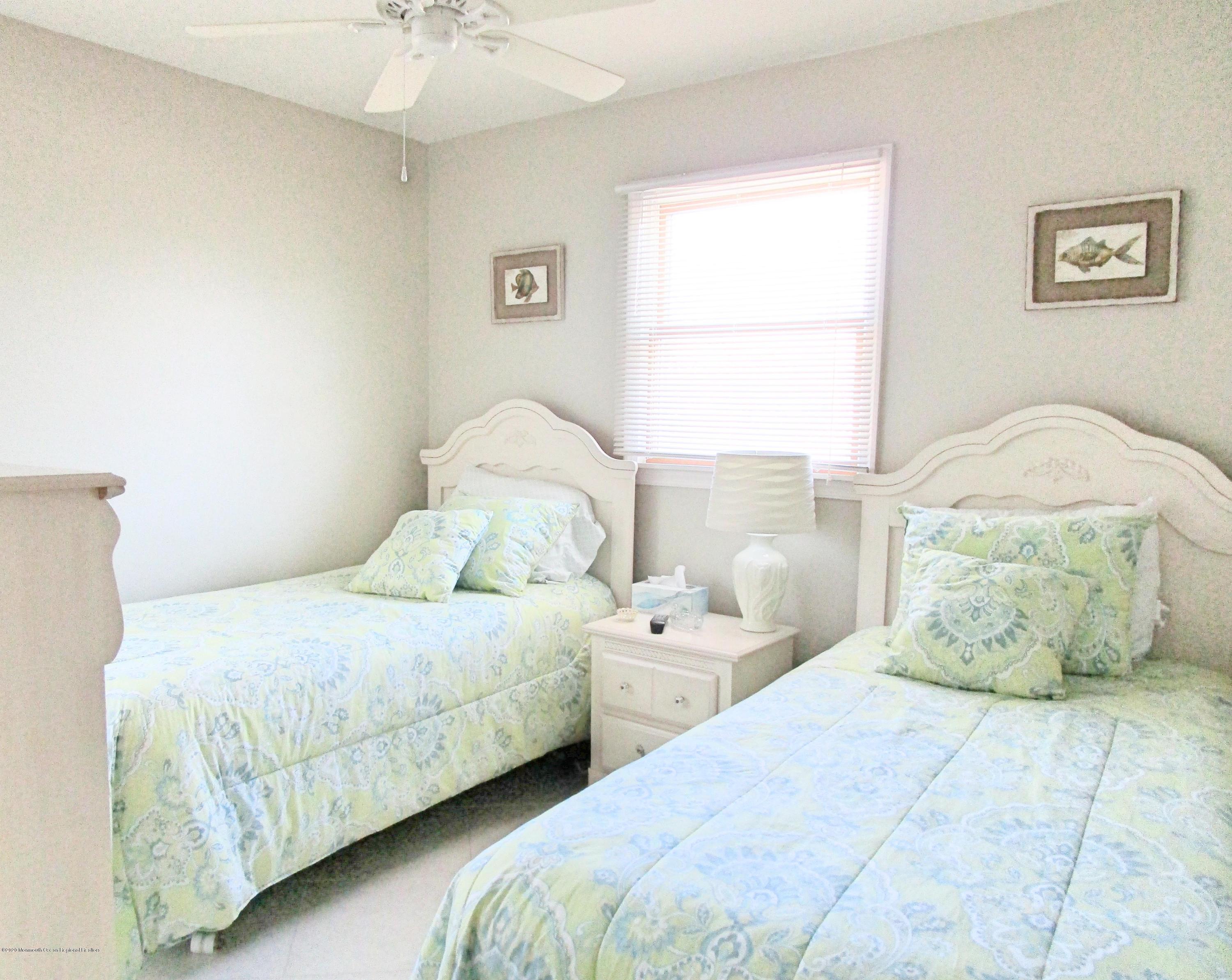 121 Jacobsen Lane Lavallette, NJ 08735 - Photo 12 of 19 a bedroom with two beds and a table