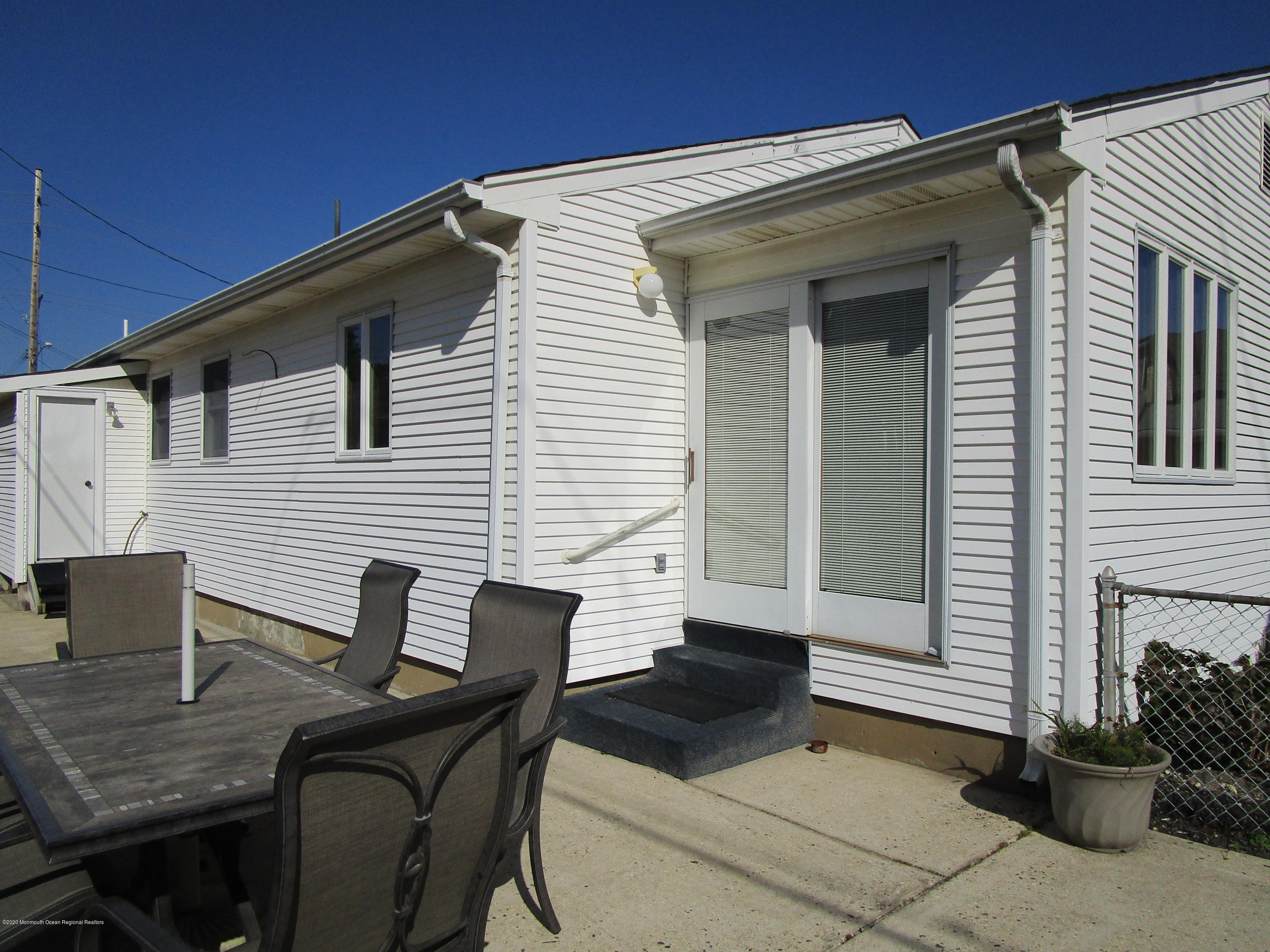 121 Jacobsen Lane Lavallette, NJ 08735 - Photo 13 of 19 a view of backyard of house with seating space
