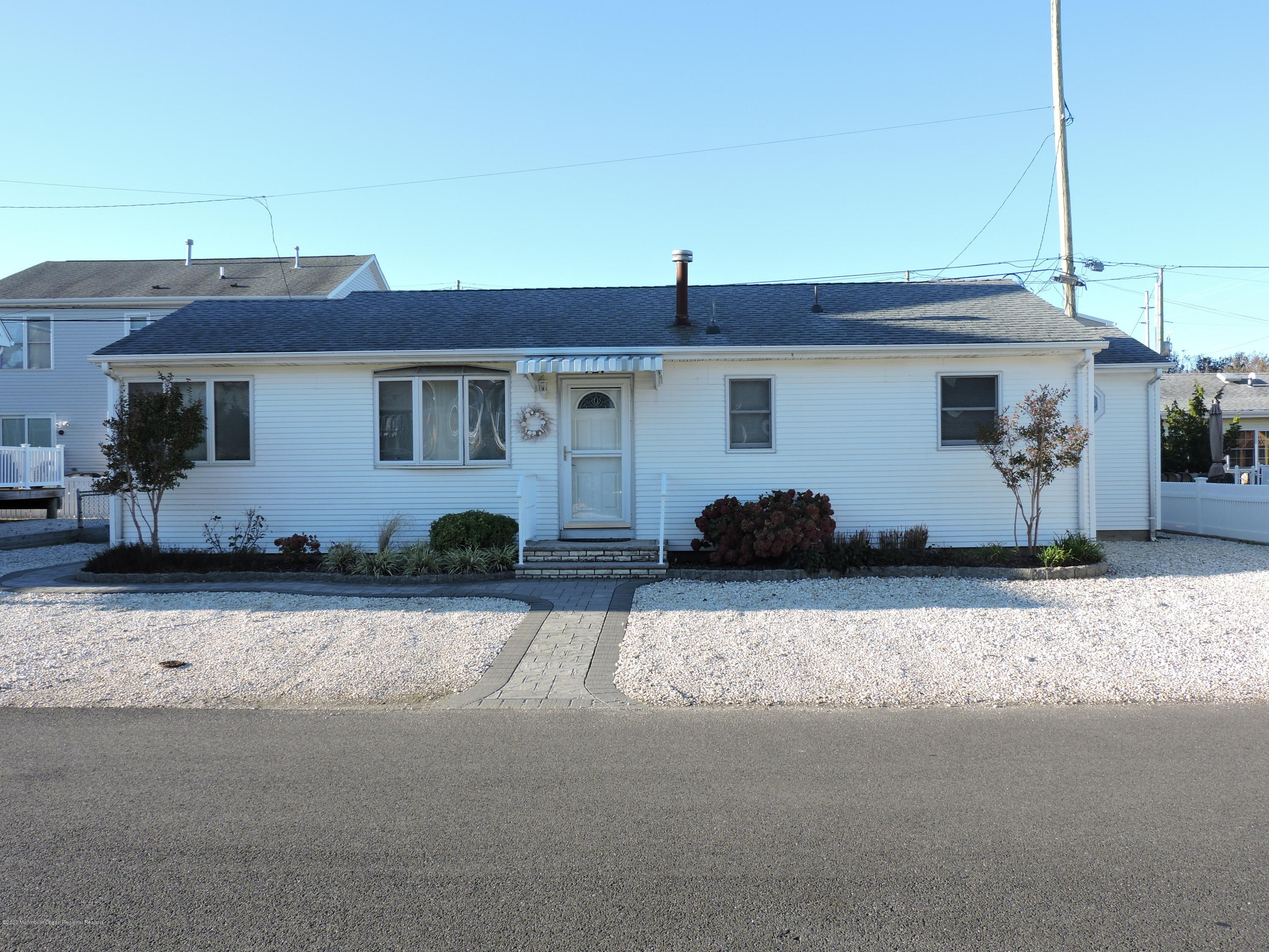 121 Jacobsen Lane Lavallette, NJ 08735 - Photo 2 of 19 a front view of a house with a yard