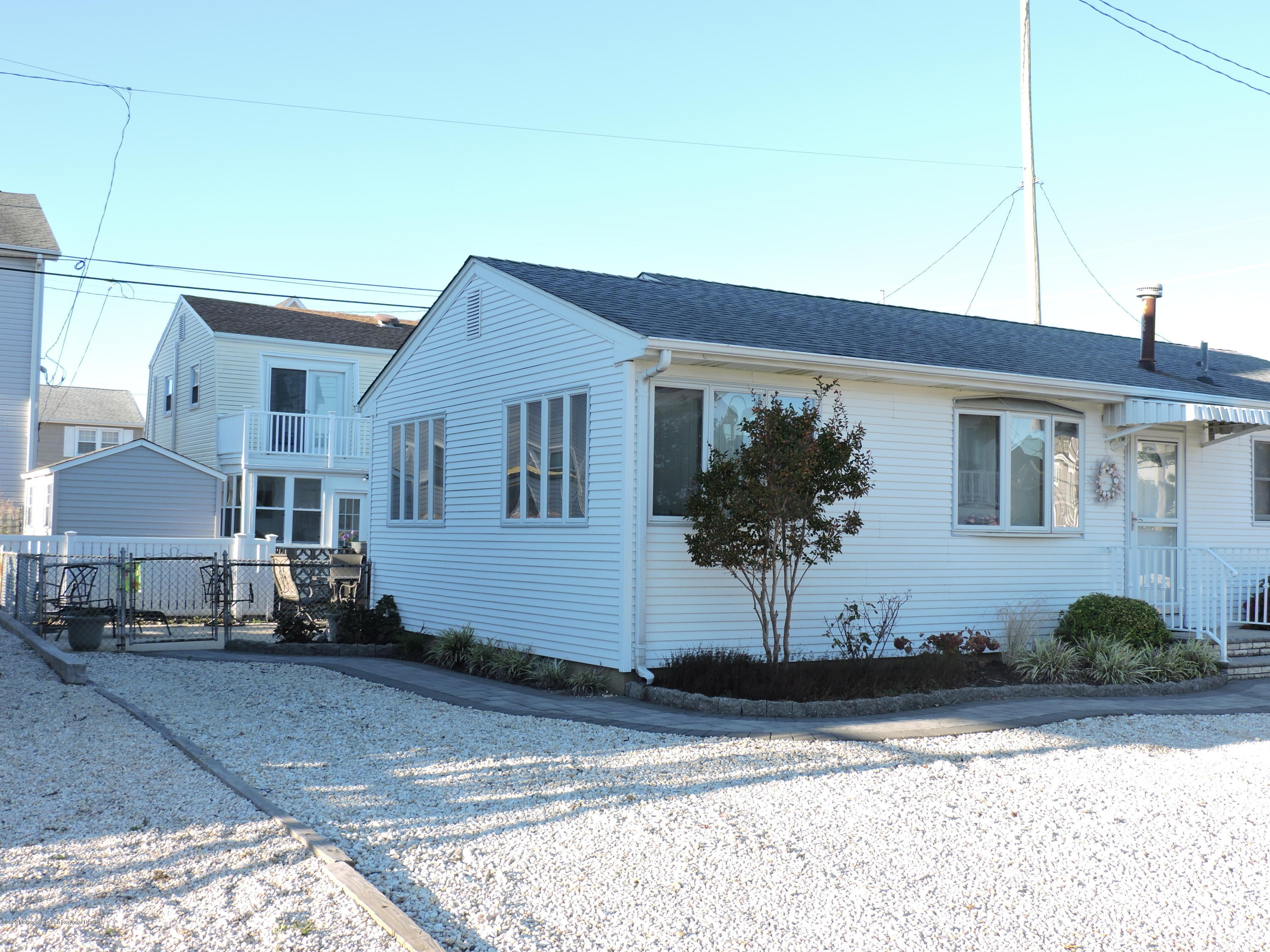 121 Jacobsen Lane Lavallette, NJ 08735 - Photo 4 of 19 a front view of a house with a yard