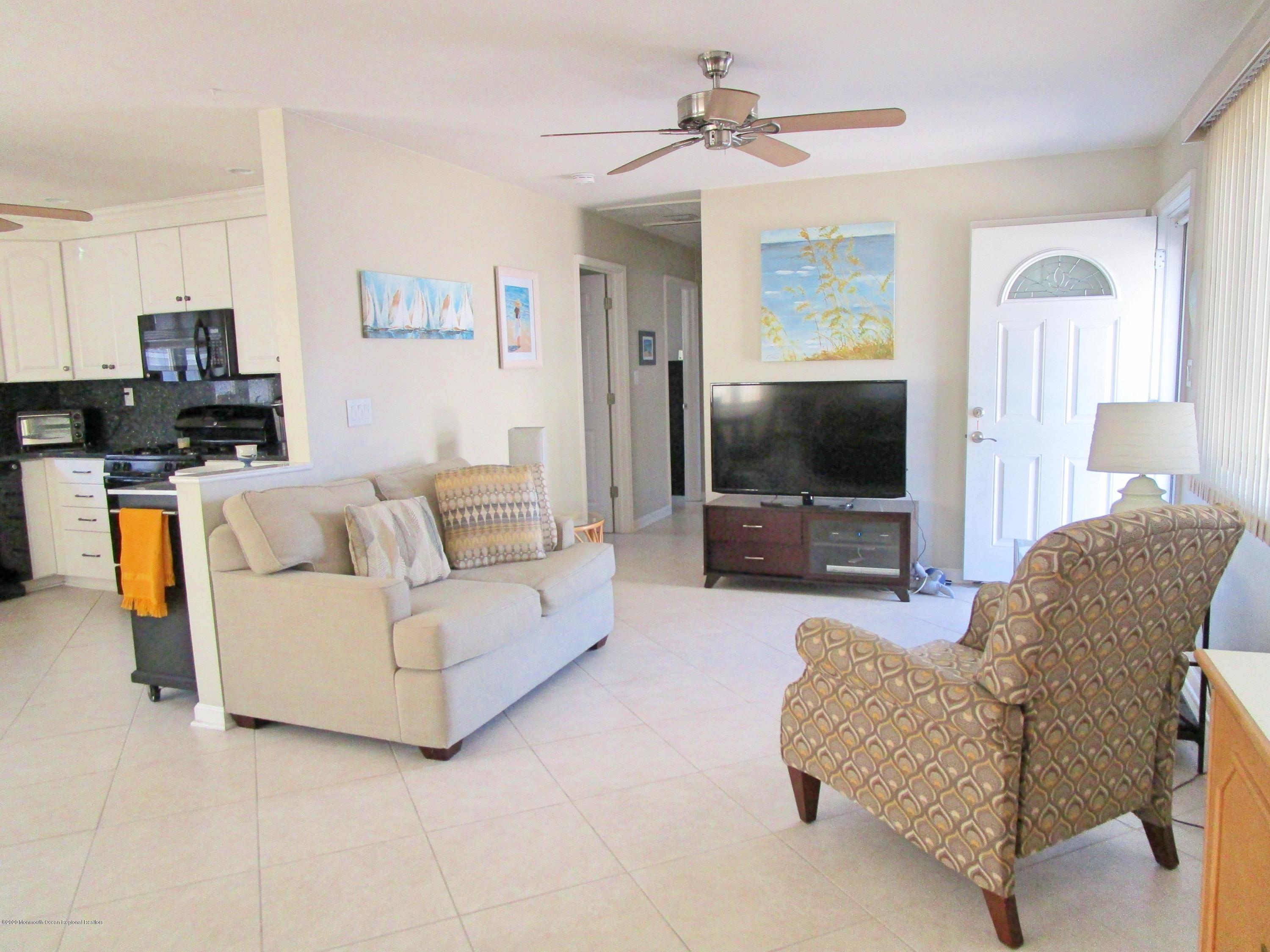121 Jacobsen Lane Lavallette, NJ 08735 - Photo 6 of 19 a living room with furniture and a flat screen tv