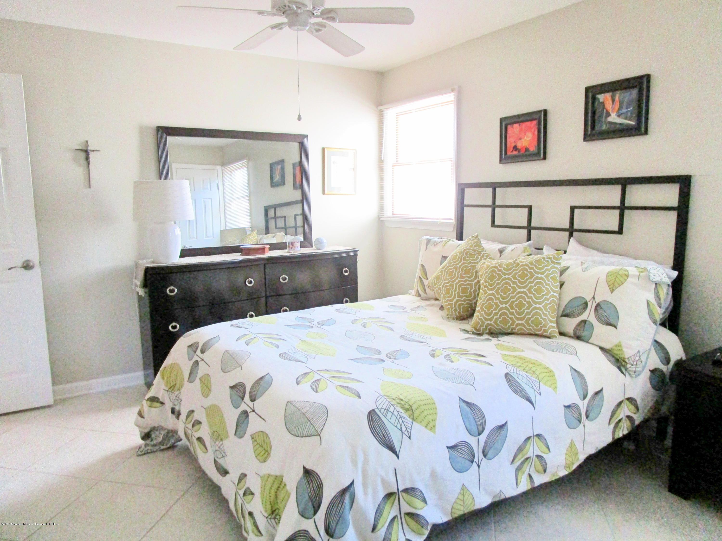 121 Jacobsen Lane Lavallette, NJ 08735 - Photo 10 of 19 a bedroom with a bed and a mirror