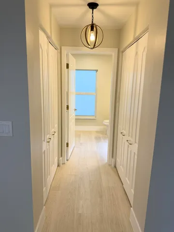 a view of a hallway with wooden floor