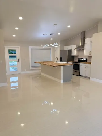 a kitchen with stainless steel appliances a refrigerator and a stove top oven
