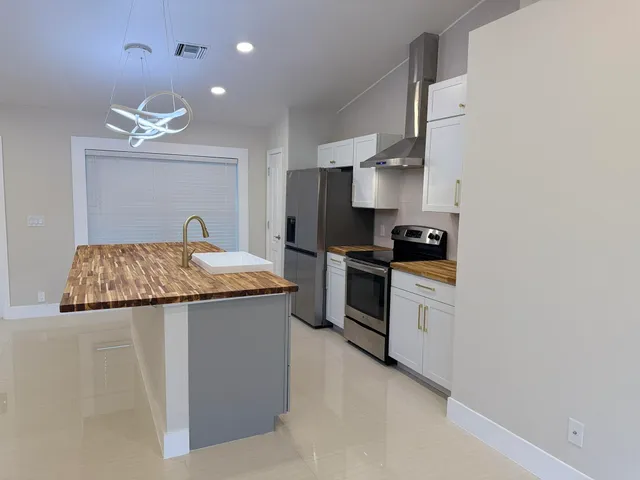 a kitchen with a sink a stove and refrigerator