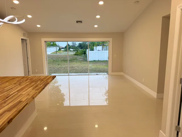 a view of a large kitchen with a large window