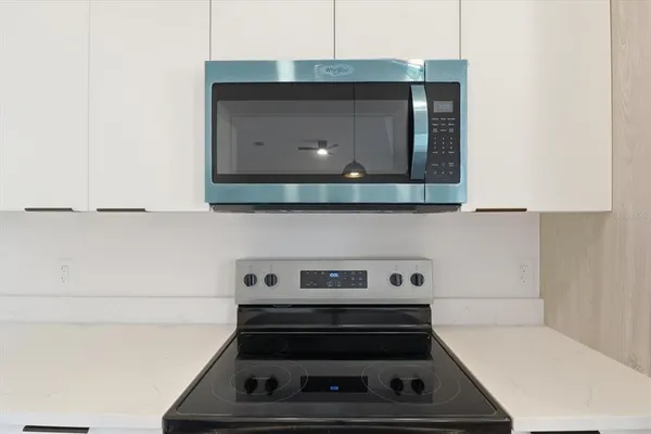 a kitchen with kitchen island a sink a counter space and a window
