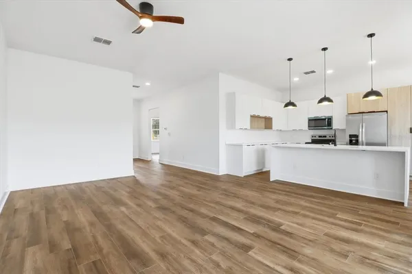 a view of kitchen with cabinets and wooden floor