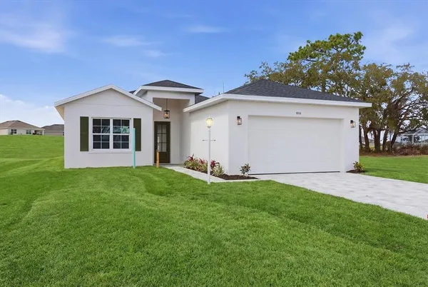 a front view of a house with a yard and garage