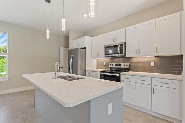 a kitchen with appliances cabinets and a sink