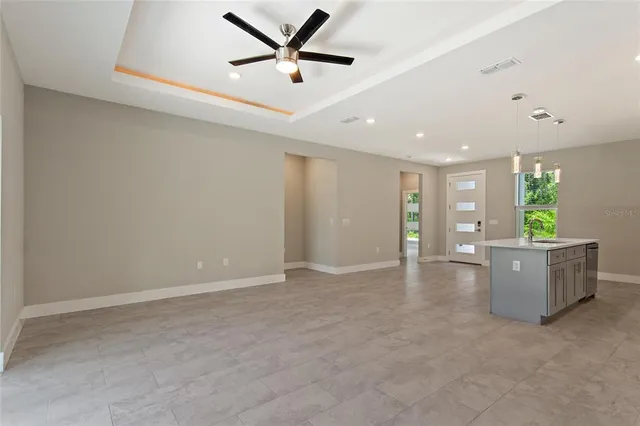 a kitchen with stainless steel appliances granite countertop a refrigerator and a stove top oven
