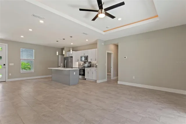 a view of a kitchen with a sink and cabinets