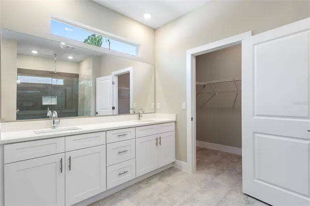 a bathroom with a double vanity sink and mirror