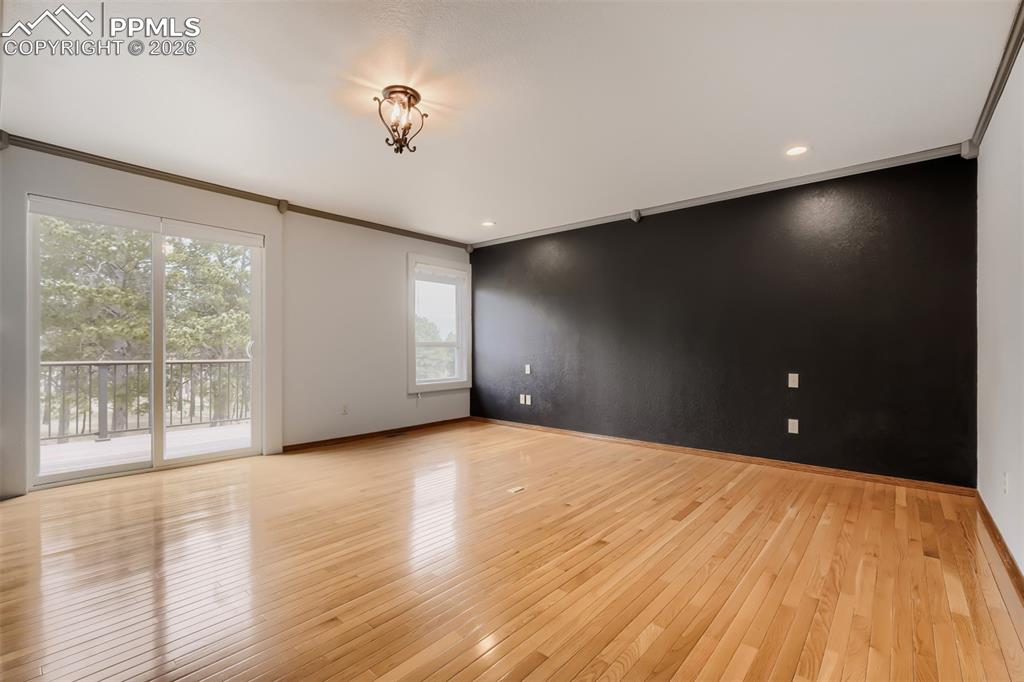 16755 Winchester Road Colorado Springs, CO 80908 - Photo 21 of 50 Primary bedroom with walk out, seating area, large walk-in closet, and remodeled bathroom.