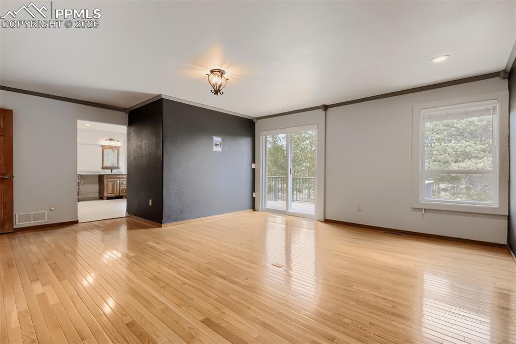 16755 Winchester Road Colorado Springs, CO 80908 - Photo 23 of 50 Primary bedroom with walk out, seating area, large walk-in closet, and remodeled bathroom.