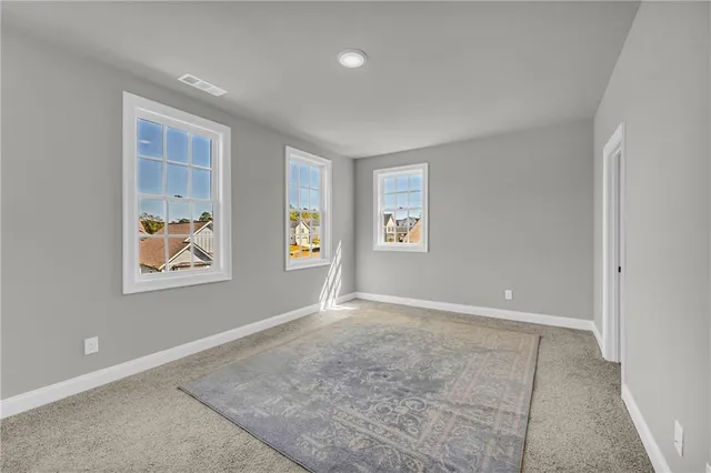 an empty room with windows and closet