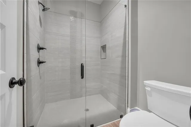 a bathroom with a shower and a toilet