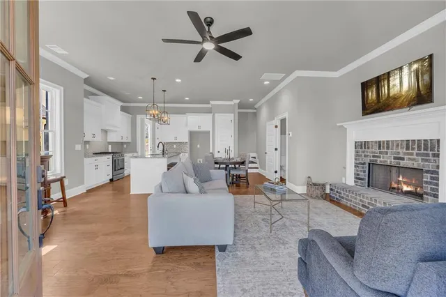a living room with furniture kitchen view and a fireplace