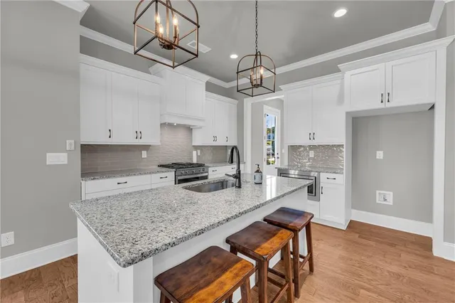 a kitchen with a counter space cabinets and wooden floor