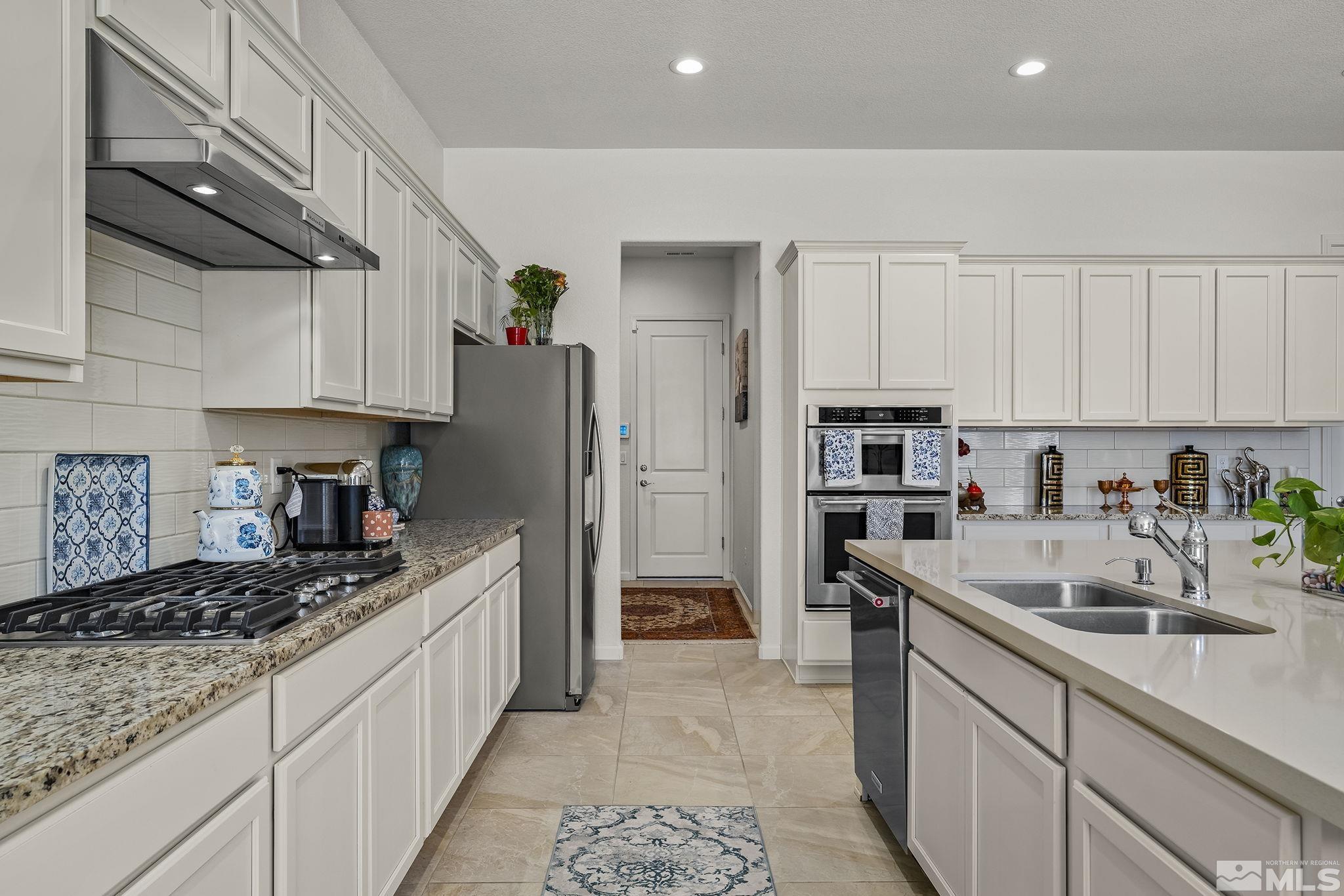 3080 Show Jumper Lane Reno, NV 89521 - Photo 13 of 40 a kitchen with stainless steel appliances granite countertop a refrigerator sink and cabinets