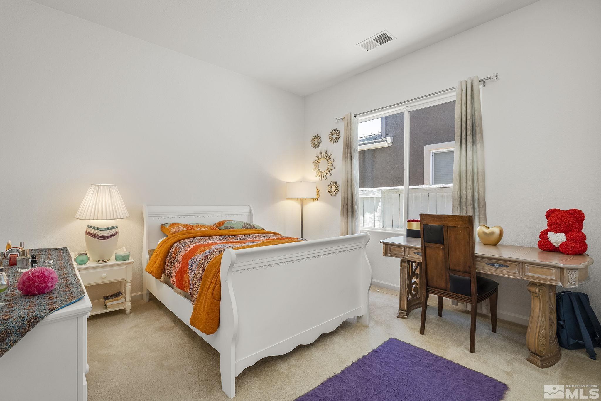 3080 Show Jumper Lane Reno, NV 89521 - Photo 22 of 40 a bedroom with a bed and a table