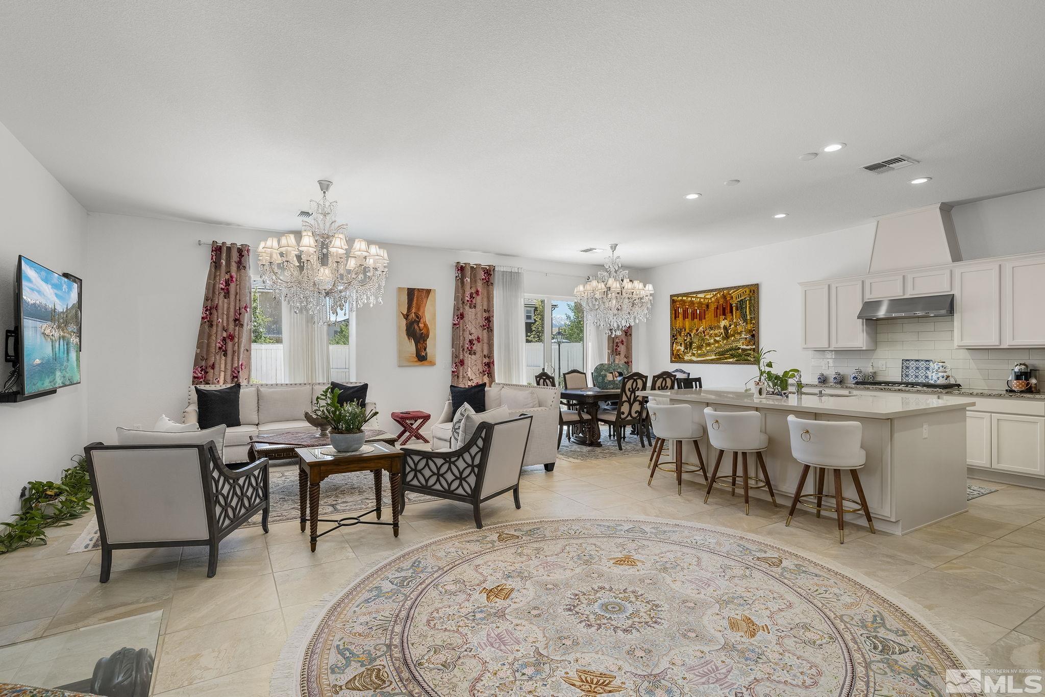 3080 Show Jumper Lane Reno, NV 89521 - Photo 4 of 40 a living room with furniture a chandelier and a dining table