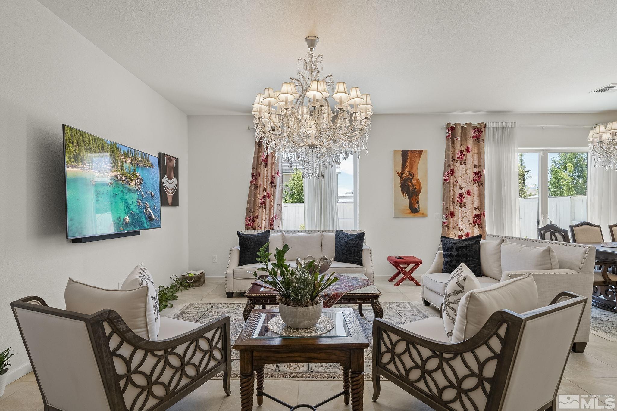 3080 Show Jumper Lane Reno, NV 89521 - Photo 5 of 40 a living room with fireplace furniture and a chandelier