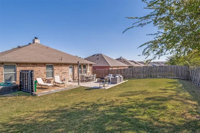 a view of a house with backyard porch and furniture