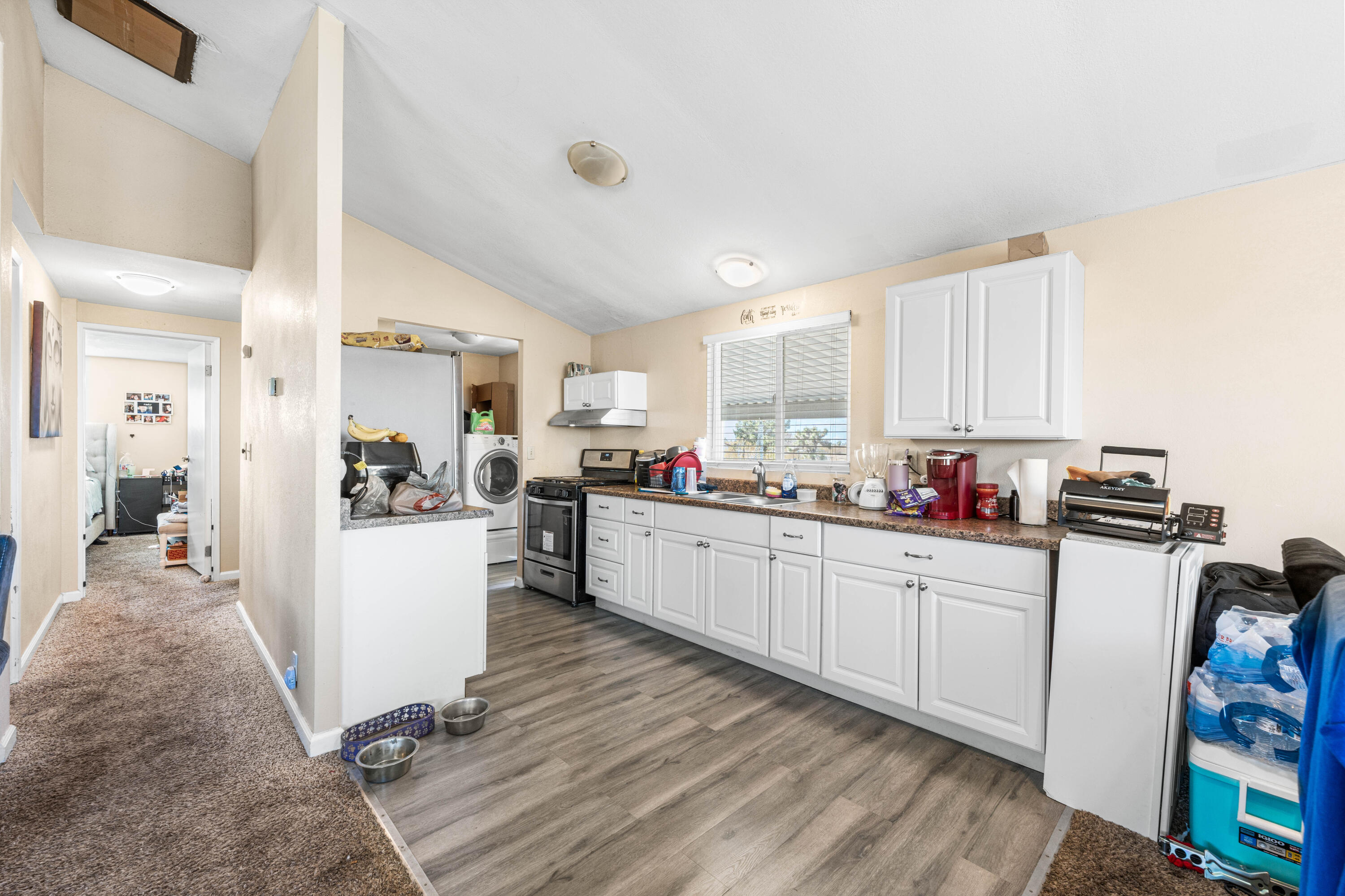 4824 Sacramento Road Phelan, CA 92371 - Photo 12 of 28 a kitchen with sink refrigerator and cabinets