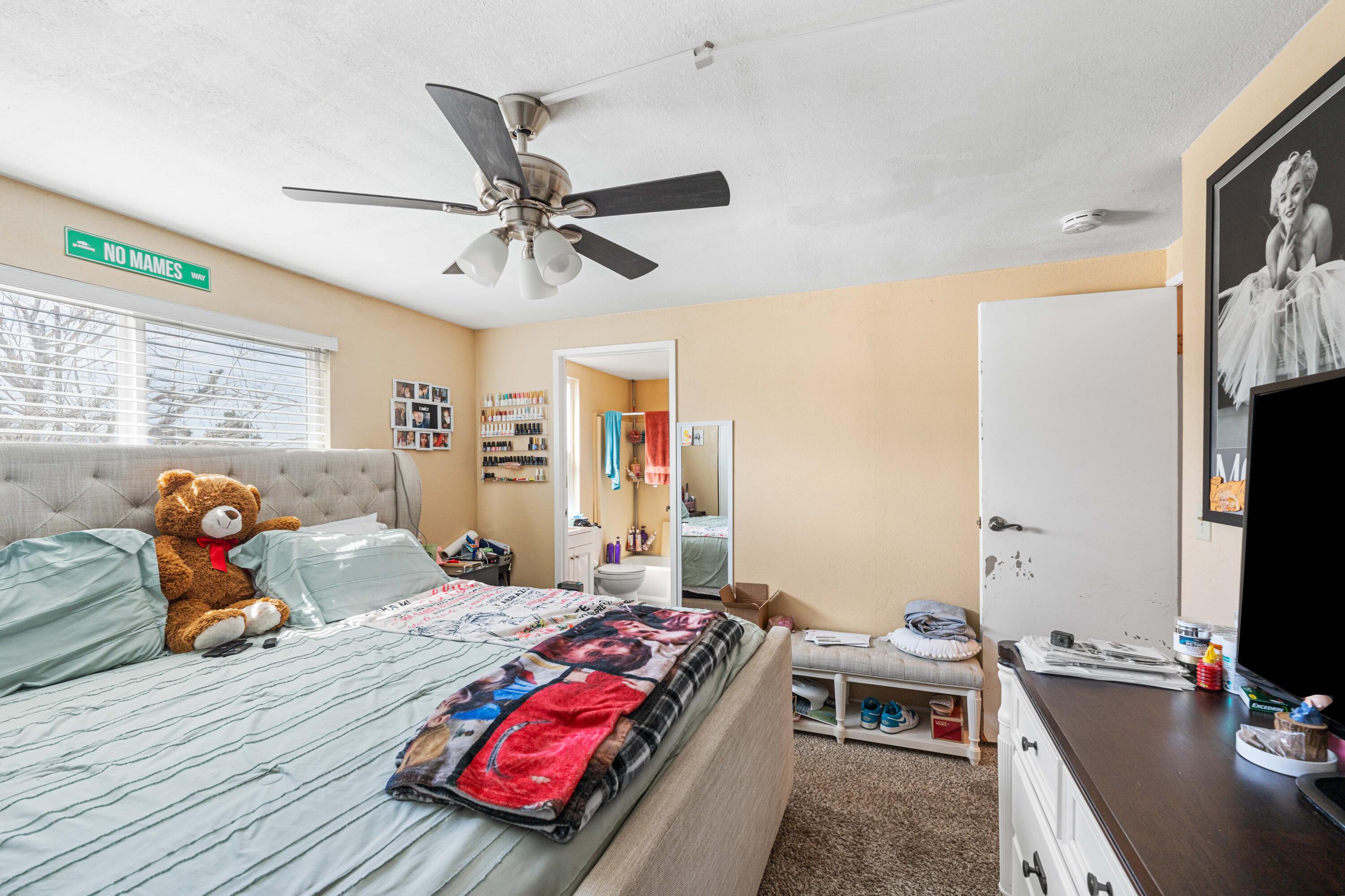 4824 Sacramento Road Phelan, CA 92371 - Photo 16 of 28 a bedroom with a bed and a flat screen tv