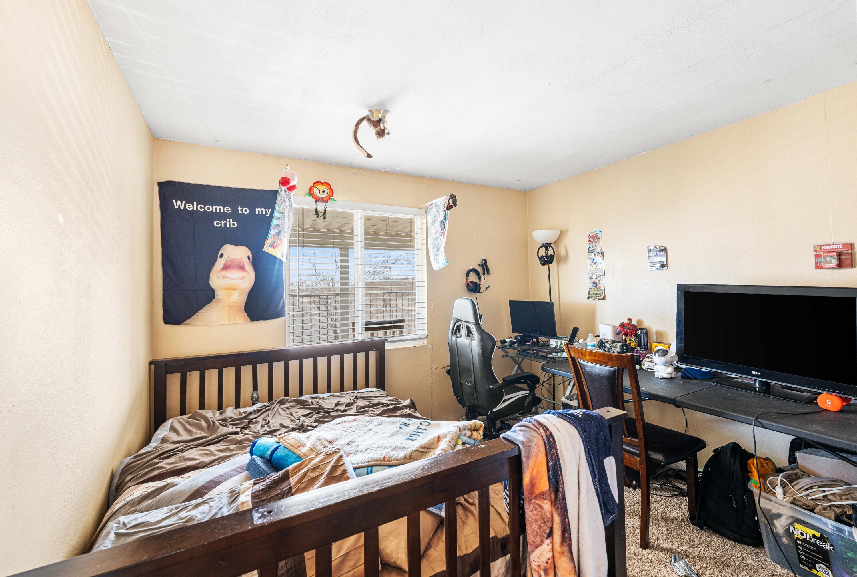 4824 Sacramento Road Phelan, CA 92371 - Photo 18 of 28 a bedroom with furniture and a flat screen tv
