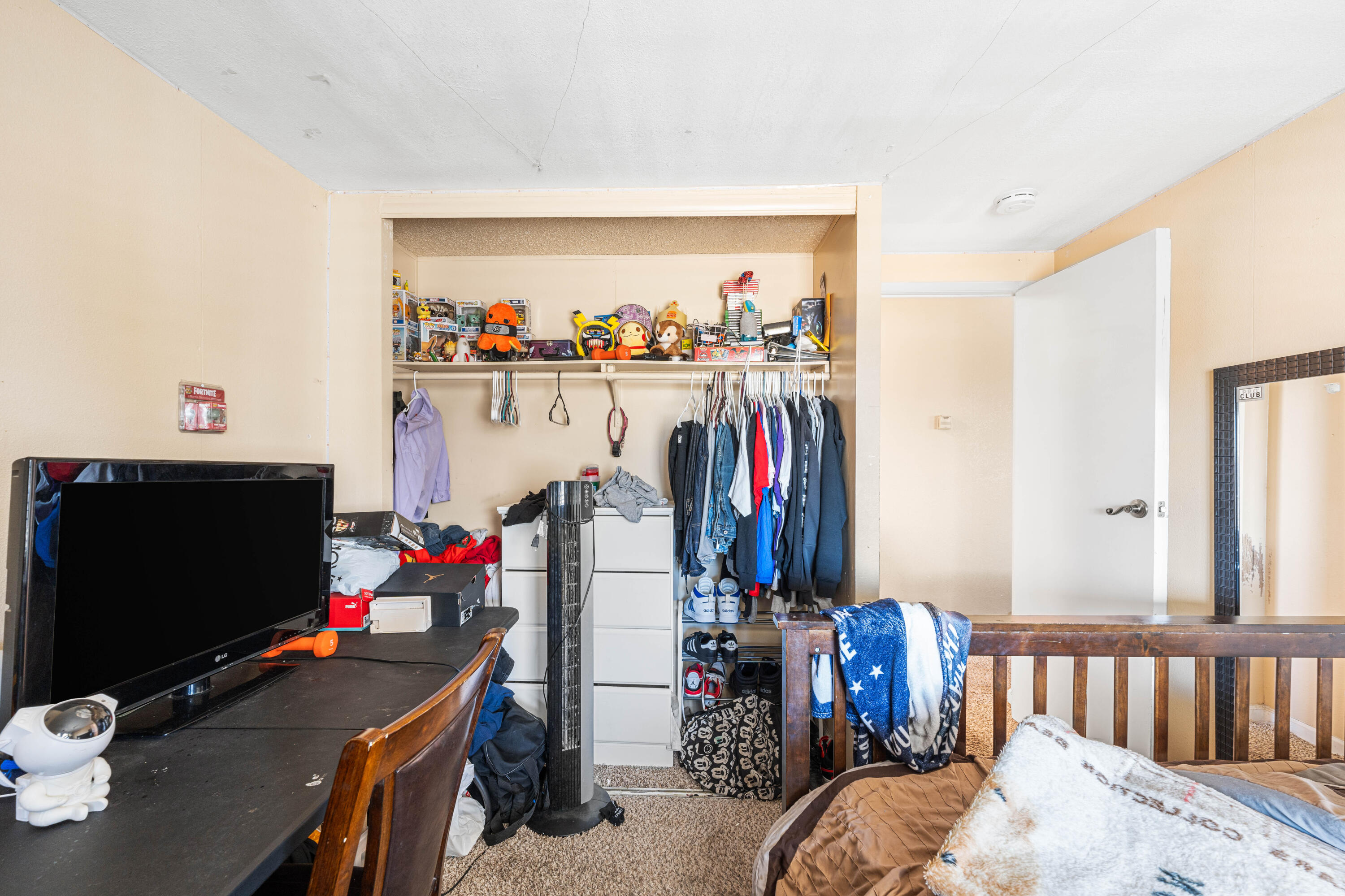 4824 Sacramento Road Phelan, CA 92371 - Photo 19 of 28 a bedroom with bed and a flat tv screen