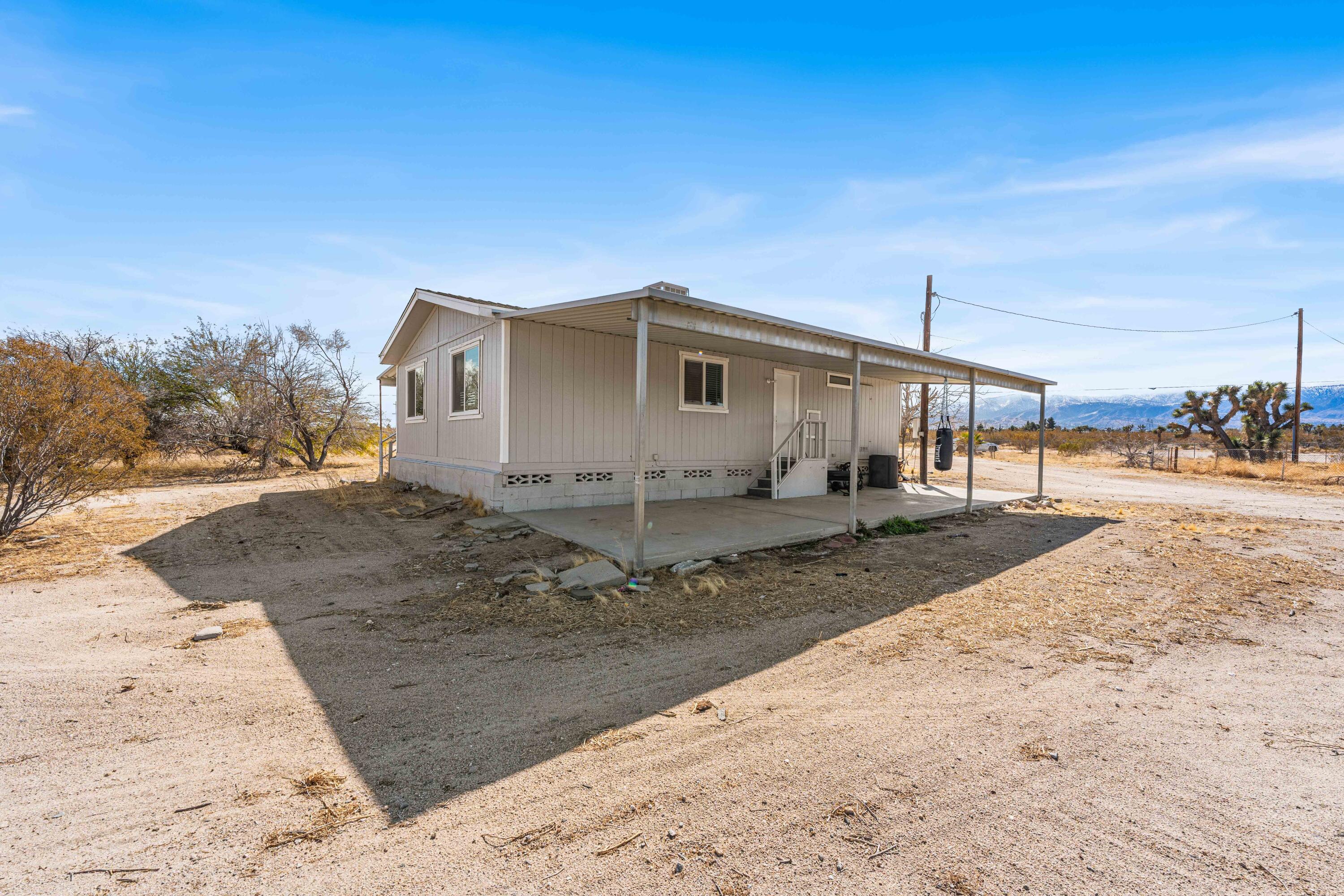 4824 Sacramento Road Phelan, CA 92371 - Photo 22 of 28 a view of a house with a backyard