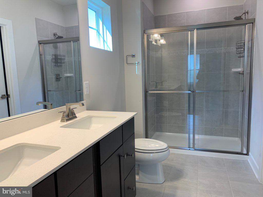 37354 Kestrel Way Ocean View, DE 19970 - Photo 8 of 18 a bathroom with a sink toilet and shower