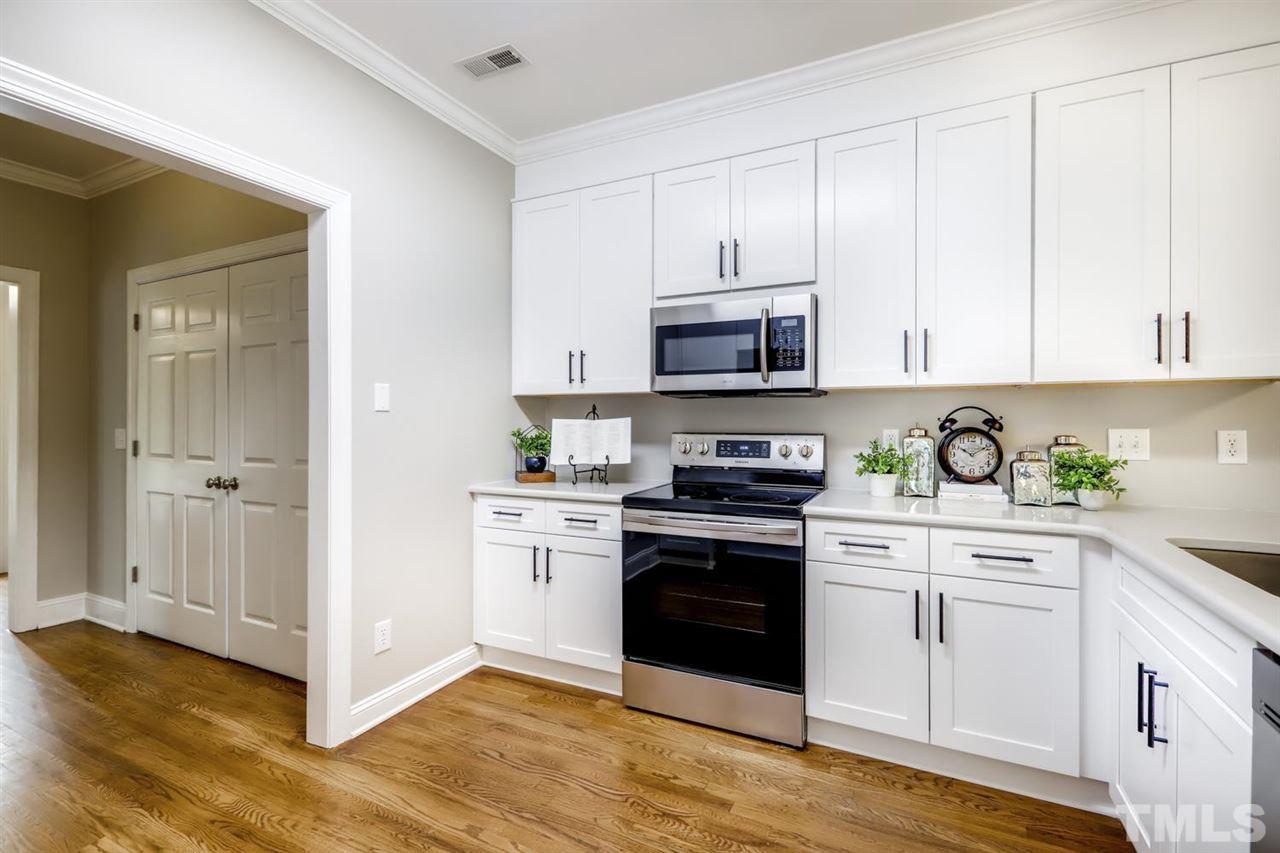 Gorgeous updates to the kitchen include NEW SOFT CLOSE cabinets, QUARTZ counters, new lighting & fixtures!  STAINLESS appliances, GLEAMING HARDWOODS & more!